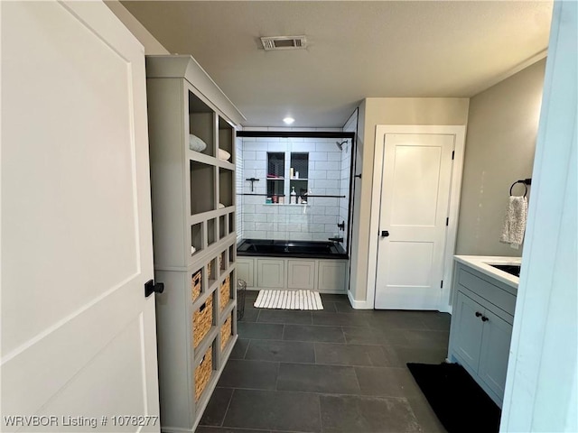 bathroom featuring shower / tub combination, vanity, and tile patterned floors