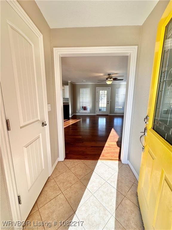 106 E Dora Ln, Poteau, OK 74953 - foyer featuring light tile patterned floors and ceiling fan
