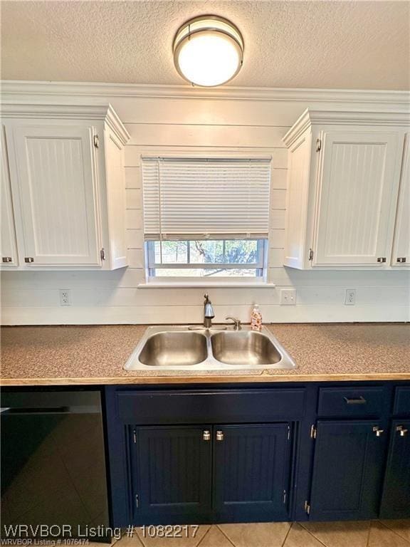 106 E Dora Ln, Poteau, OK 74953 - kitchen featuring dishwasher, blue cabinetry, a textured ceiling, white cabinets, and light tile patterned floors