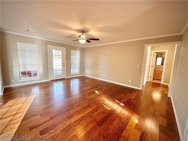 106 E Dora Ln, Poteau, OK 74953 - spare room featuring dark wood-type flooring, ceiling fan, and ornamental molding