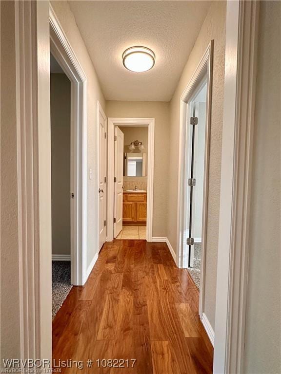 106 E Dora Ln, Poteau, OK 74953 - hall with wood finished floors and a textured ceiling