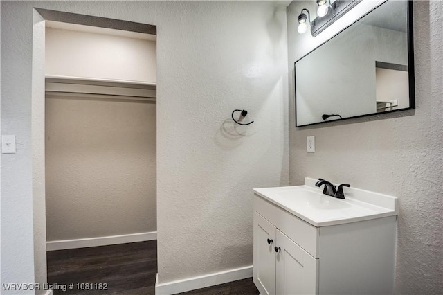 3614 Blair Ave, Fort Smith, AR 70903 - bathroom featuring wood finished floors, vanity, baseboards, and a textured wall