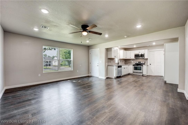 3614 Blair Ave, Fort Smith, AR 70903 - unfurnished living room featuring a ceiling fan, baseboards, dark wood finished floors, a sink, and recessed lighting