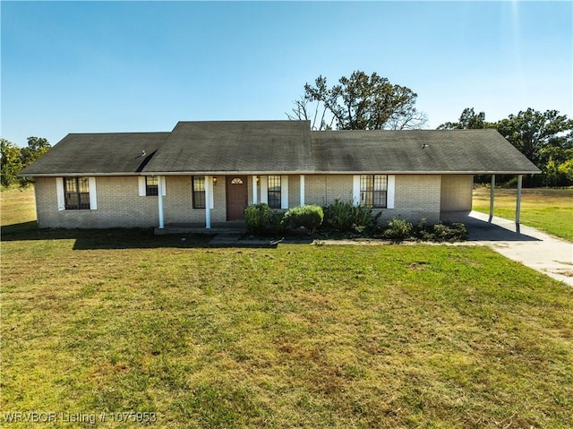 ranch-style home with a carport and a front lawn