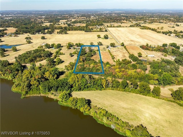 drone / aerial view featuring a water view and a rural view