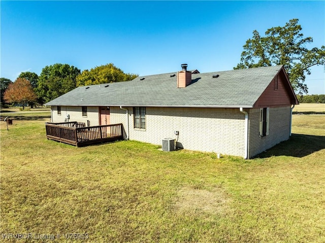 back of house featuring a wooden deck, a yard, and central air condition unit