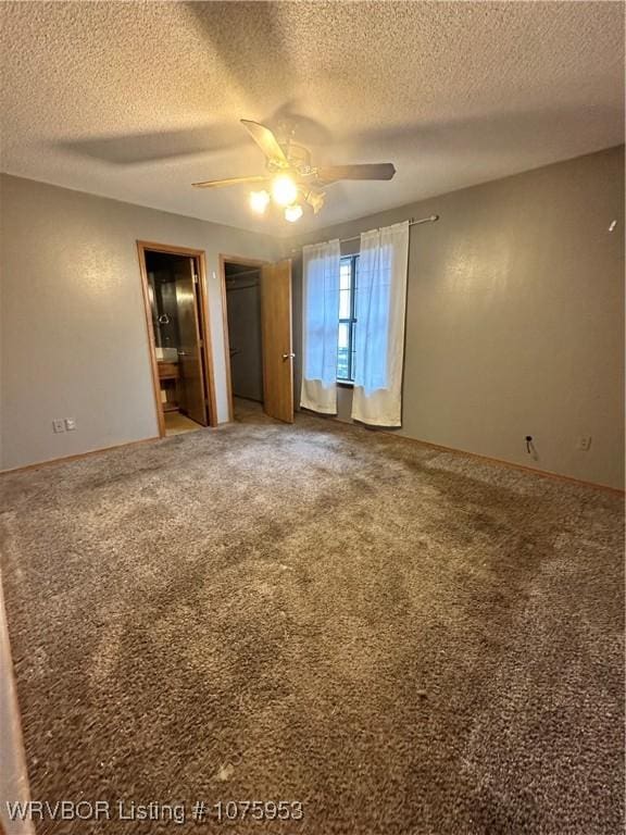 spare room featuring ceiling fan, carpet floors, and a textured ceiling