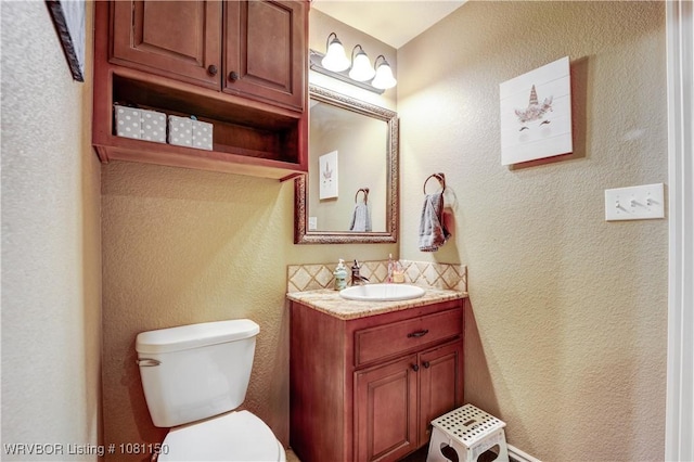 2304 Durango Dr, Van Buren, AR 72956 - bathroom featuring toilet, a textured wall, vanity, and backsplash