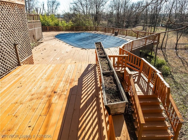 view of swimming pool featuring a deck