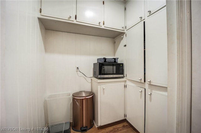 kitchen with dark hardwood / wood-style floors and white cabinetry