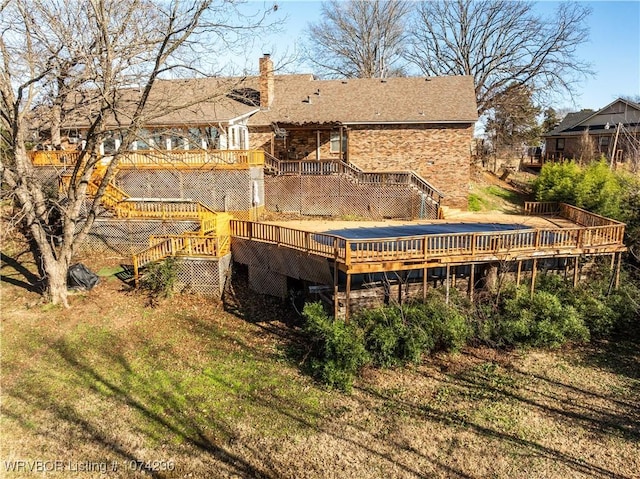 rear view of property featuring a deck