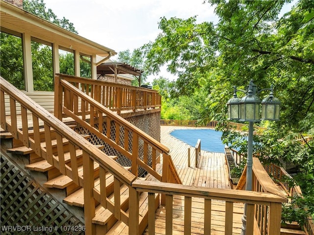 wooden terrace with a covered pool