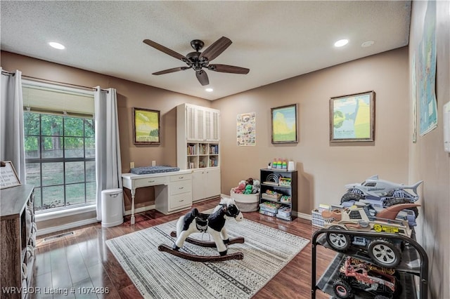 interior space with ceiling fan, hardwood / wood-style floors, and a textured ceiling