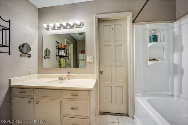 bathroom featuring tile patterned floors, vanity, and bathing tub / shower combination