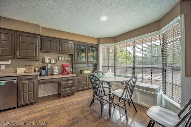 dining room with hardwood / wood-style floors and a textured ceiling