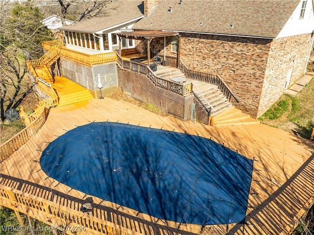 view of swimming pool featuring a wooden deck