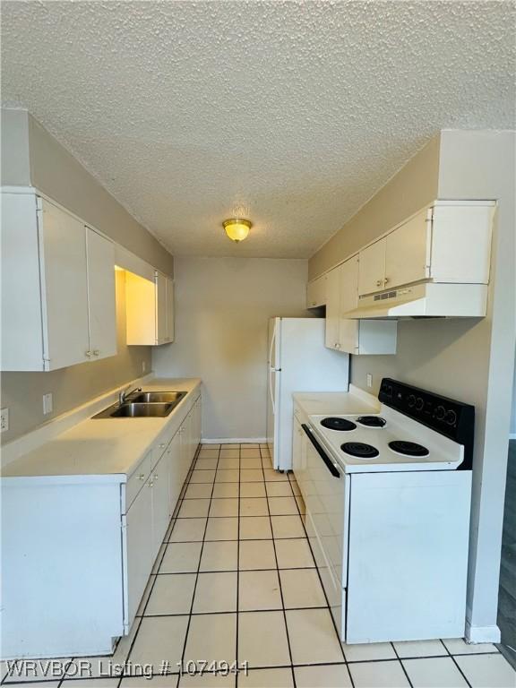 kitchen featuring white cabinets, light tile patterned floors, white appliances, and sink