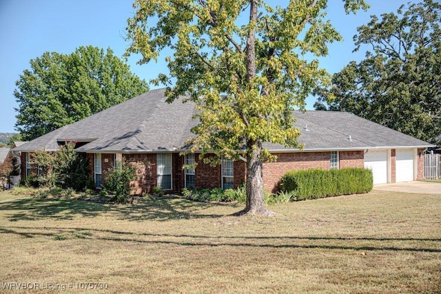 view of front of property with a front yard and a garage