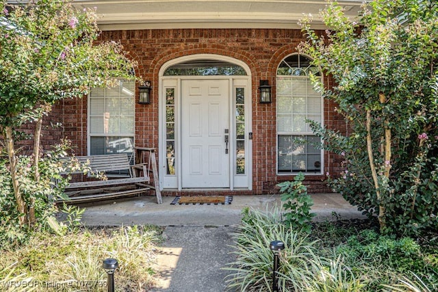 view of exterior entry featuring a porch