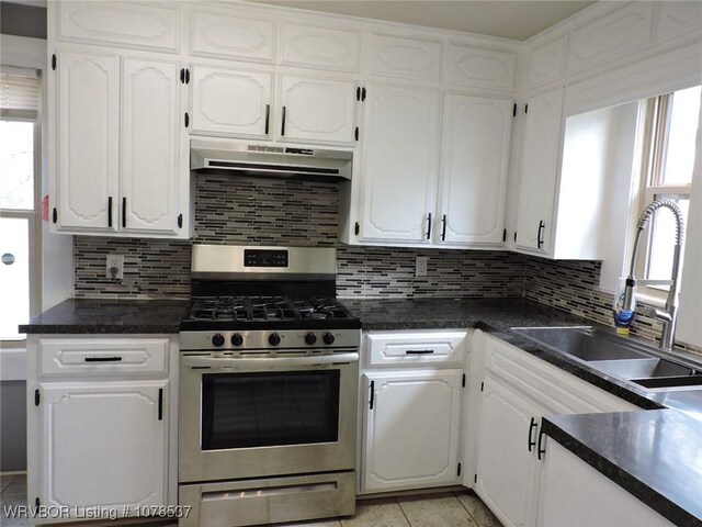 kitchen with pendant lighting, light tile patterned floors, sink, white cabinets, and kitchen peninsula