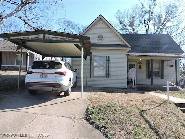 view of front of property with a front yard and a carport