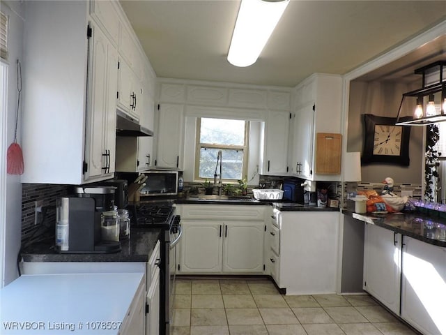 kitchen with sink, stainless steel appliances, tasteful backsplash, white cabinets, and light tile patterned flooring