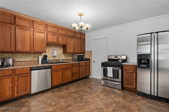 kitchen featuring crown molding, stainless steel appliances, a notable chandelier, and brown cabinetry