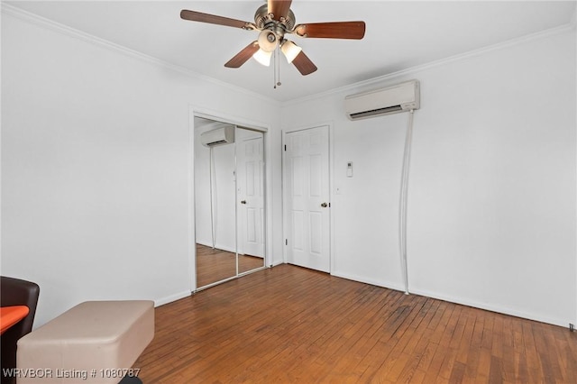 unfurnished bedroom with ornamental molding, a ceiling fan, hardwood / wood-style floors, and an AC wall unit