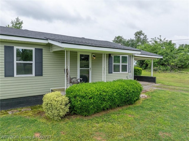 view of front of home featuring a front lawn and an attached carport