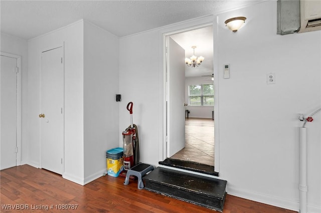 interior space with baseboards, ceiling fan with notable chandelier, and wood finished floors