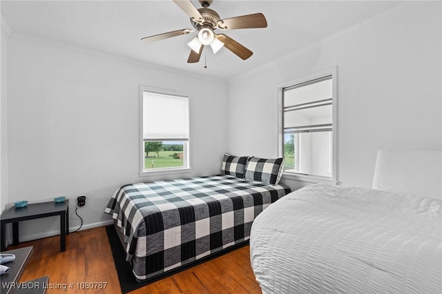 bedroom with ceiling fan, ornamental molding, and wood finished floors