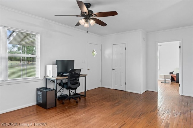 office featuring ceiling fan, hardwood / wood-style flooring, plenty of natural light, and ornamental molding