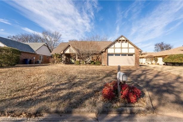 view of front of house featuring a garage and a front lawn