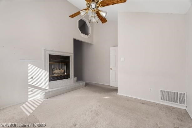 unfurnished living room with ceiling fan, light colored carpet, and high vaulted ceiling