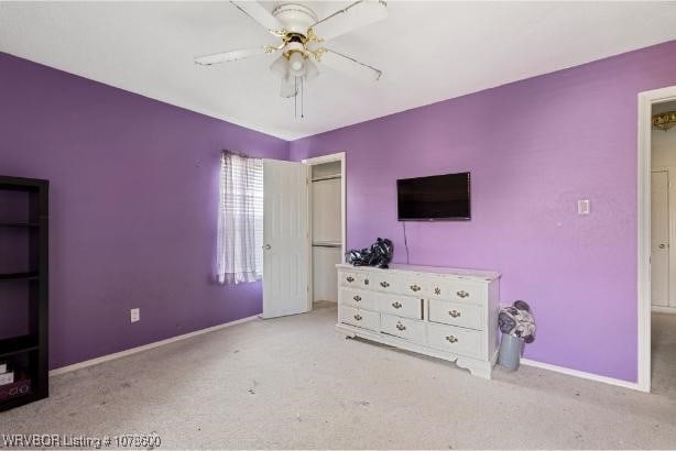 unfurnished bedroom featuring light colored carpet and ceiling fan