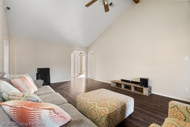 living room featuring beam ceiling, dark wood-type flooring, high vaulted ceiling, and ceiling fan