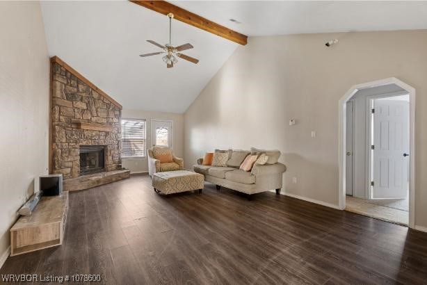 unfurnished living room featuring a stone fireplace, dark hardwood / wood-style floors, high vaulted ceiling, ceiling fan, and beam ceiling