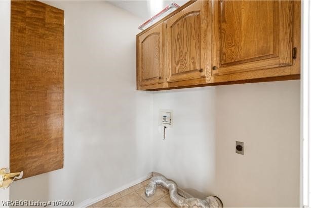 laundry room with cabinets, washer hookup, and electric dryer hookup