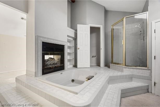 bathroom with independent shower and bath and a multi sided fireplace