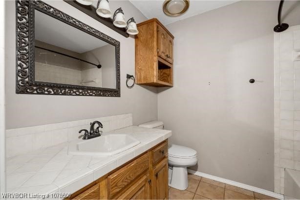 full bathroom with tile patterned flooring, vanity, bathtub / shower combination, and toilet