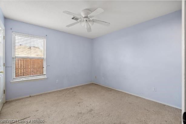 spare room with light carpet and ceiling fan