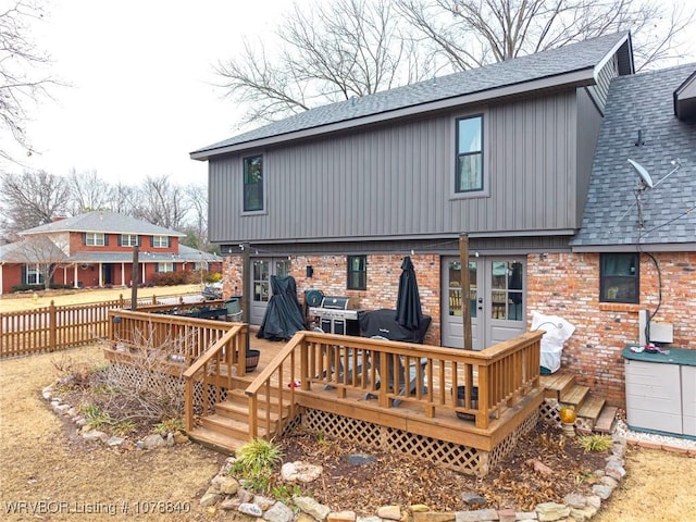 rear view of property featuring a deck