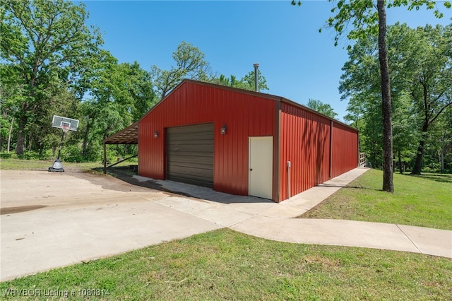 garage featuring driveway and a detached garage