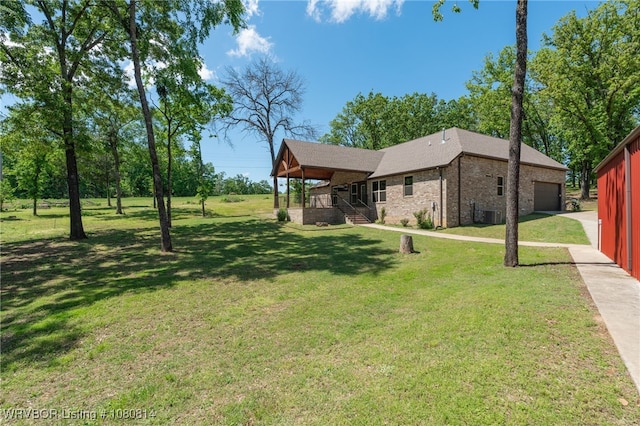 view of yard with covered porch, stairs, and driveway