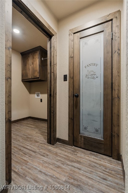 interior space with baseboards and wood finished floors