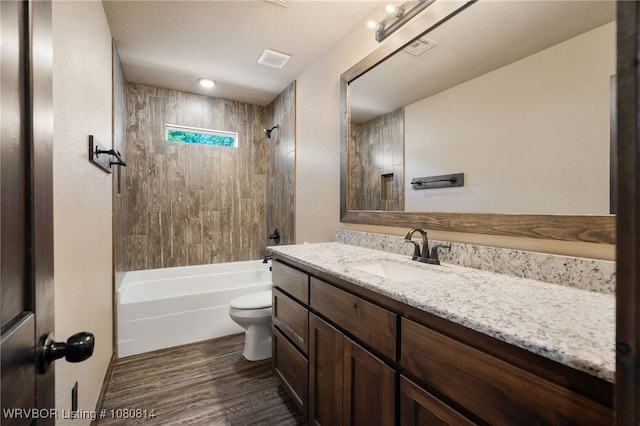 full bathroom featuring toilet, visible vents, shower / tub combination, vanity, and wood finished floors
