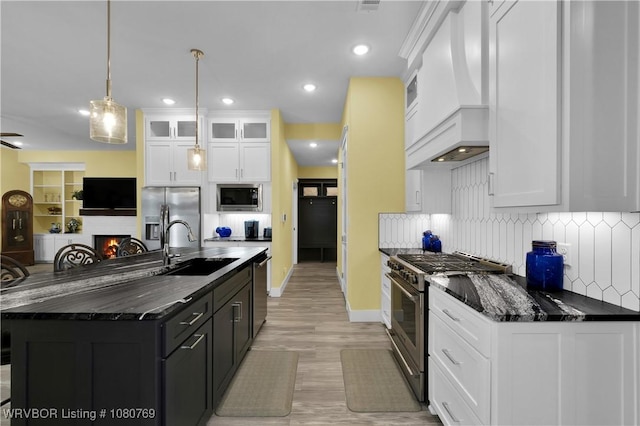 9100 Kirkwood Rd, Fort Smith, AR 72916 - kitchen with a sink, stainless steel appliances, white cabinets, premium range hood, and tasteful backsplash