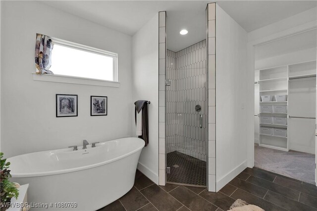 9100 Kirkwood Rd, Fort Smith, AR 72916 - full bathroom with a shower stall, a freestanding bath, a walk in closet, tile patterned floors, and recessed lighting