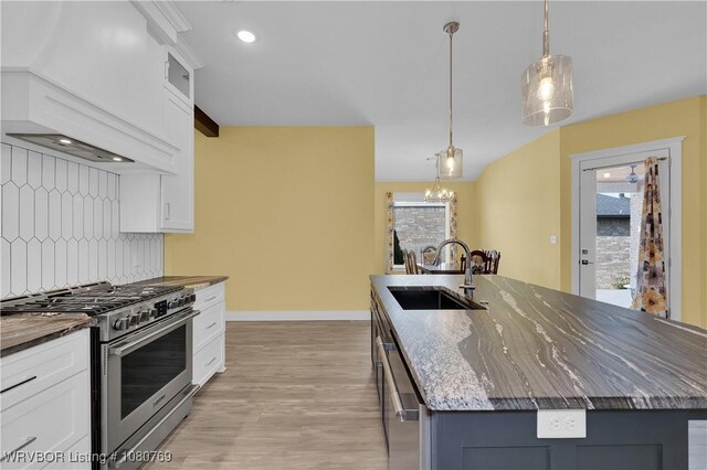 9100 Kirkwood Rd, Fort Smith, AR 72916 - kitchen featuring appliances with stainless steel finishes, dark stone counters, custom exhaust hood, light wood-style flooring, and a center island with sink