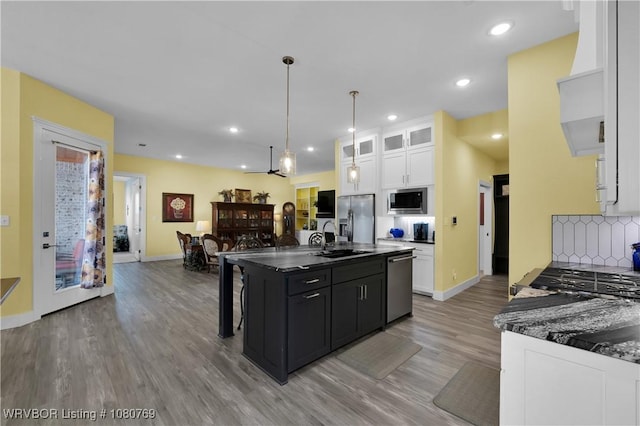 9100 Kirkwood Rd, Fort Smith, AR 72916 - kitchen featuring a sink, dark countertops, stainless steel appliances, white cabinets, and light wood-style floors